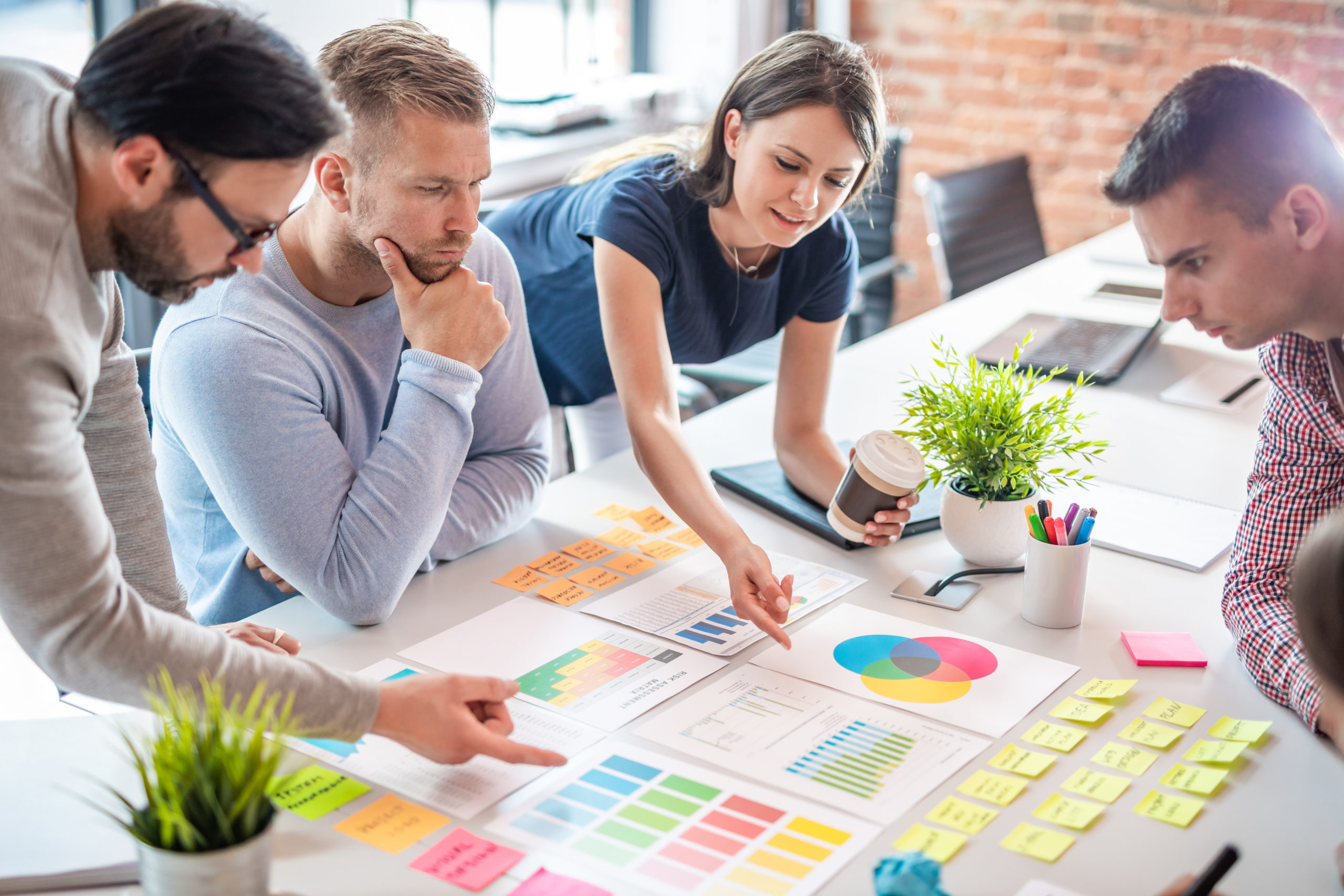 people working together looking at colorful charts